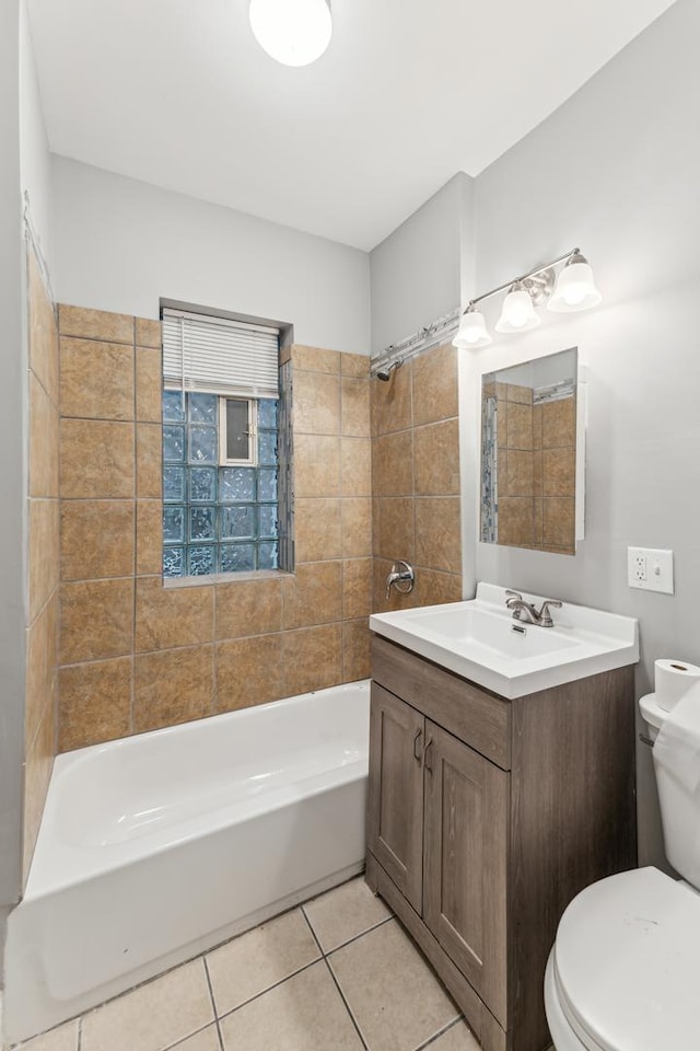 full bathroom with tile patterned floors, toilet, vanity, and tiled shower / bath