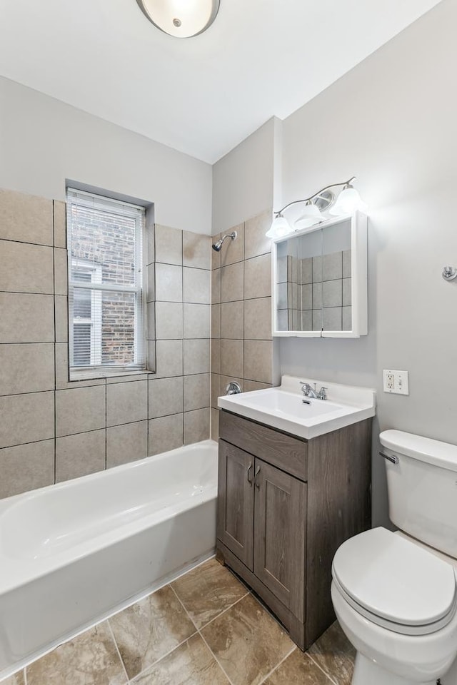 full bathroom with vanity, tiled shower / bath combo, and toilet