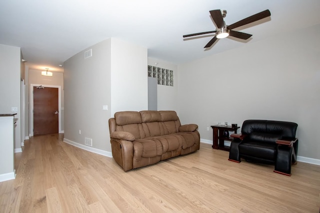 living room featuring light wood-type flooring and ceiling fan