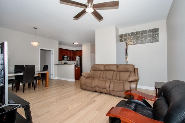 living room with ceiling fan and light hardwood / wood-style floors