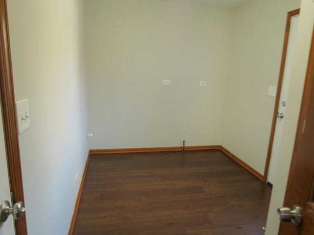 spare room with dark hardwood / wood-style floors