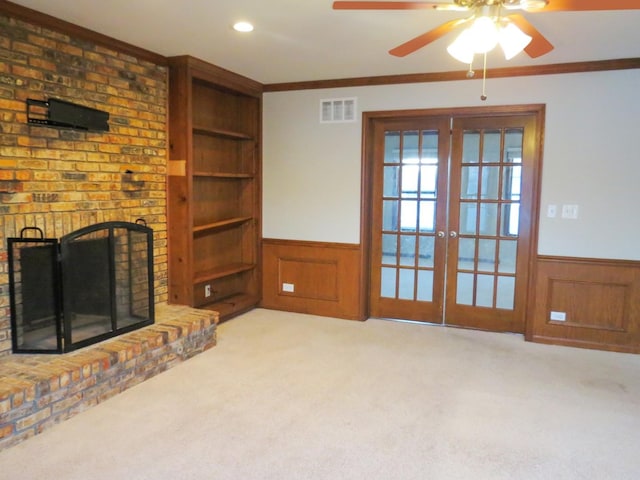 living room with ceiling fan, ornamental molding, light carpet, and french doors