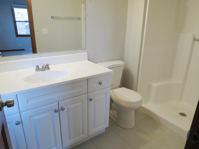 bathroom with tile patterned floors, vanity, toilet, and a shower