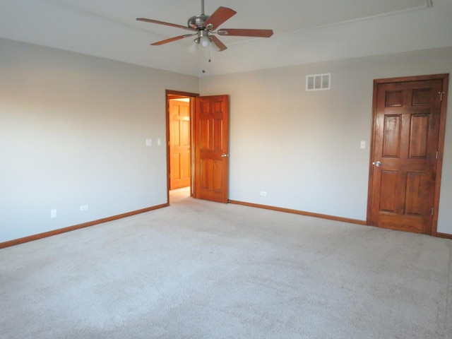 carpeted spare room featuring ceiling fan