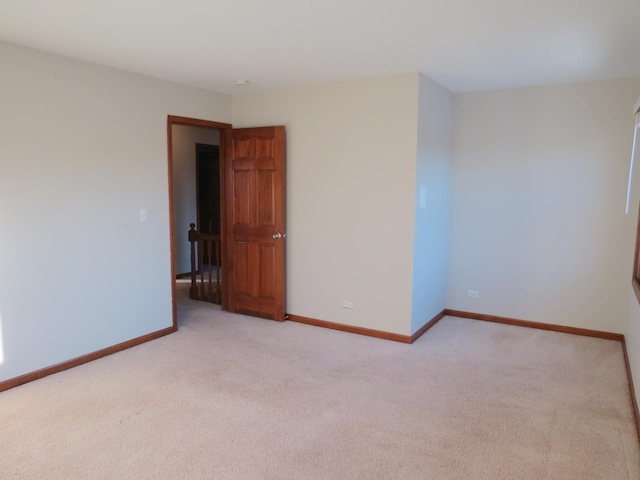 unfurnished room featuring light carpet