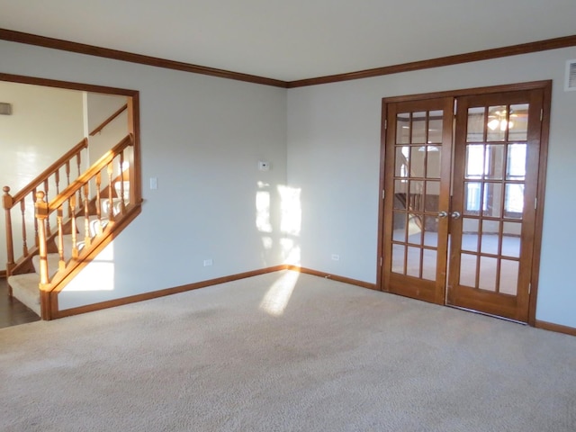 carpeted empty room featuring french doors and ornamental molding