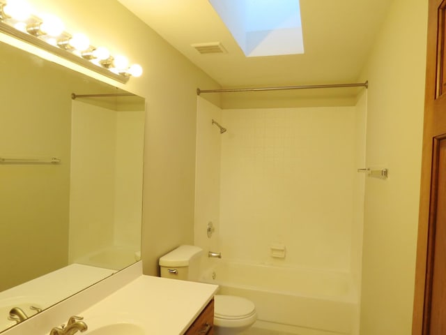 full bathroom with vanity, a skylight, toilet, and shower / washtub combination