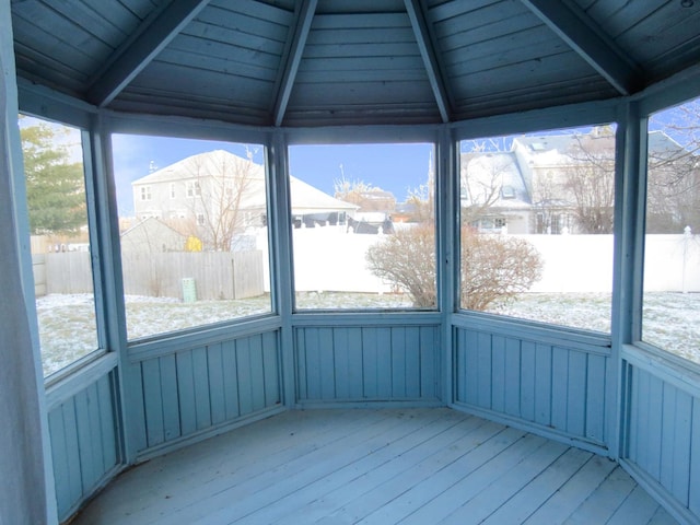 unfurnished sunroom with lofted ceiling with beams and wood ceiling