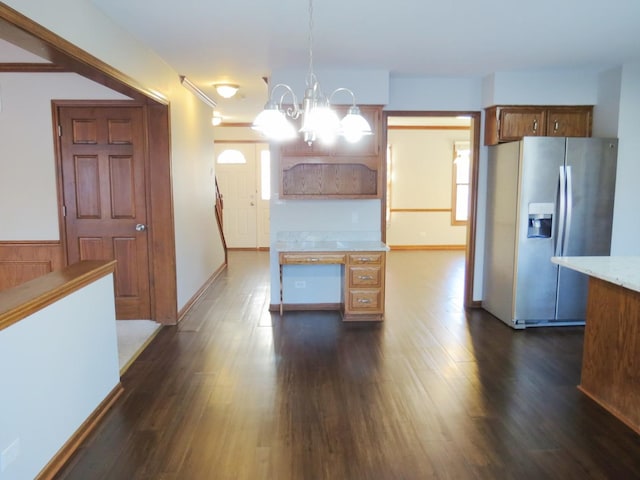 kitchen featuring stainless steel fridge with ice dispenser, dark hardwood / wood-style floors, an inviting chandelier, and pendant lighting