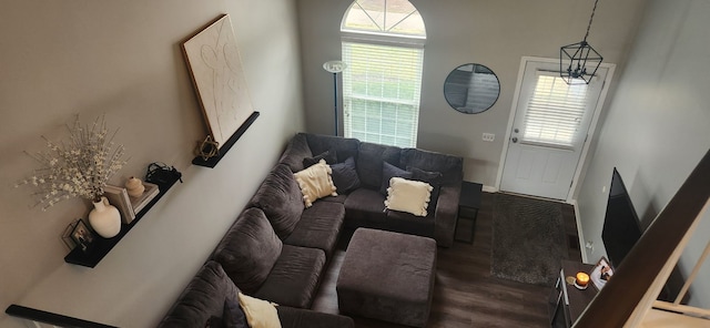 living room with hardwood / wood-style floors and an inviting chandelier