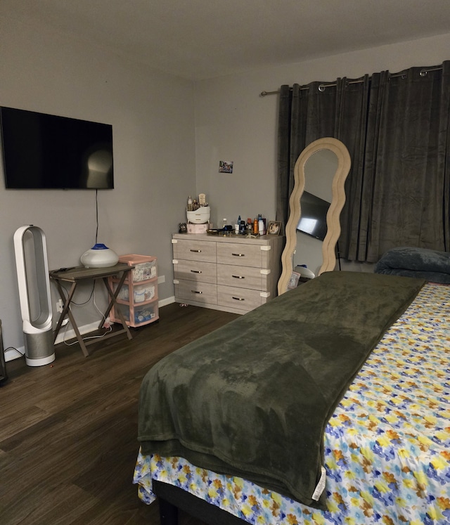 bedroom with dark hardwood / wood-style floors