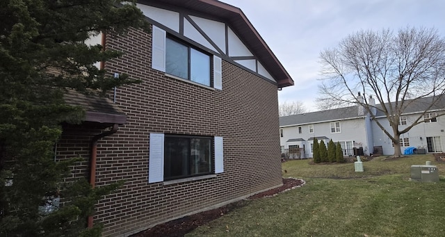 view of side of home featuring a yard