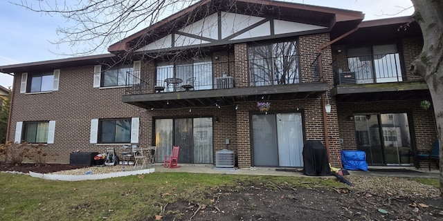 back of property featuring a balcony and central air condition unit