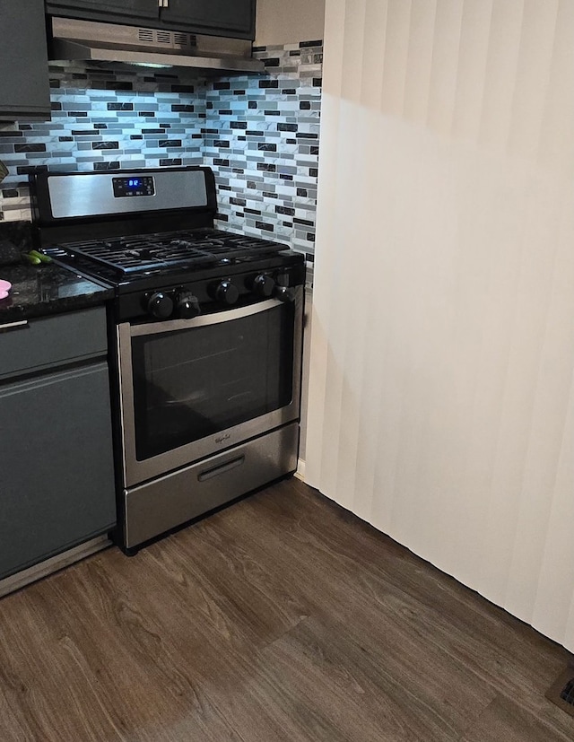 kitchen with gas range, decorative backsplash, dark hardwood / wood-style floors, and range hood