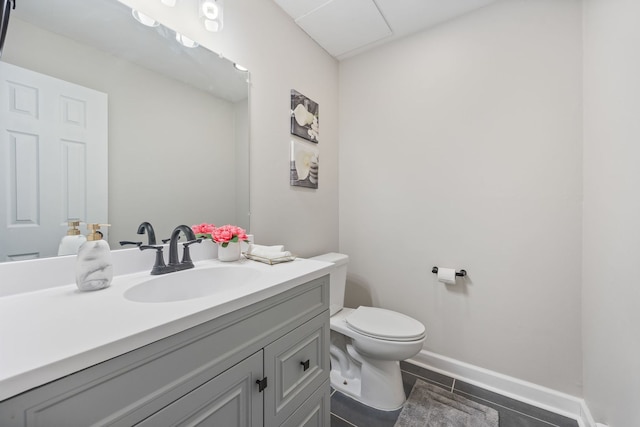 bathroom with tile patterned flooring, vanity, and toilet