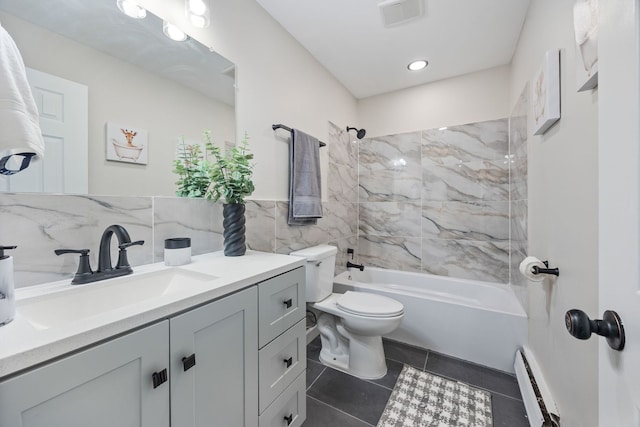 full bathroom with tile patterned floors, vanity, tiled shower / bath combo, a baseboard heating unit, and toilet