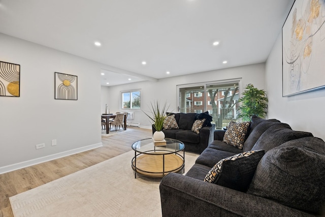 living room with light hardwood / wood-style flooring and a baseboard heating unit