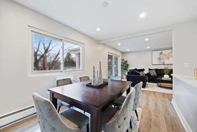 dining area with a baseboard radiator and light hardwood / wood-style floors