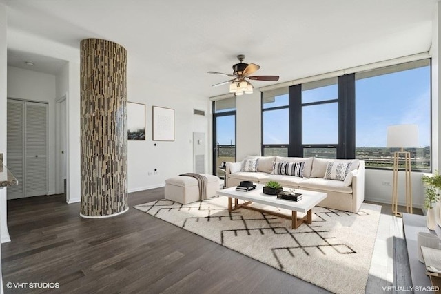 living room with dark hardwood / wood-style flooring and ceiling fan