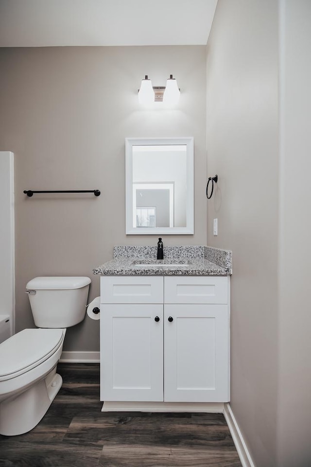 bathroom featuring hardwood / wood-style floors, vanity, and toilet