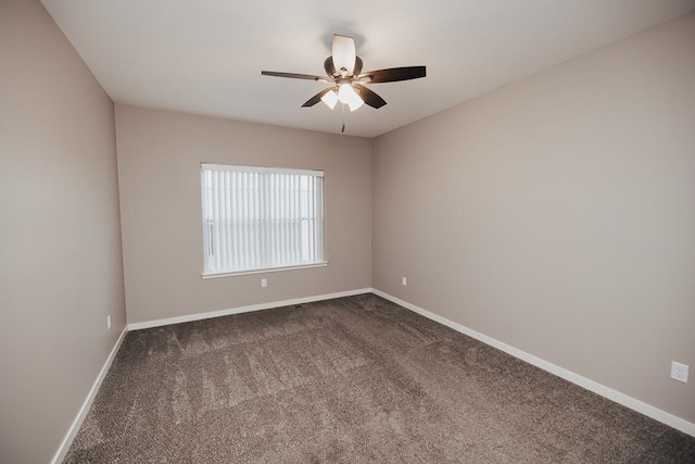 carpeted spare room featuring ceiling fan