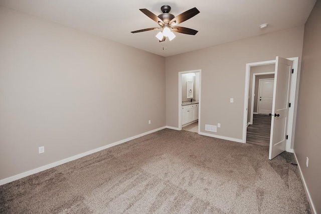 unfurnished bedroom with light colored carpet, ensuite bath, and ceiling fan