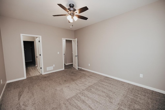 unfurnished bedroom featuring connected bathroom, ceiling fan, and carpet