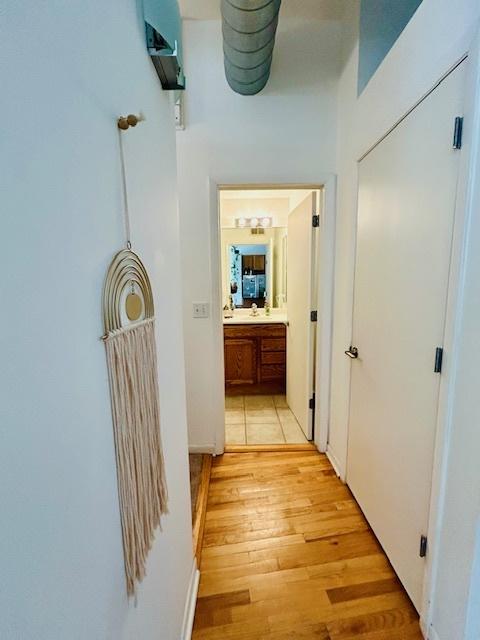 hallway with light hardwood / wood-style flooring