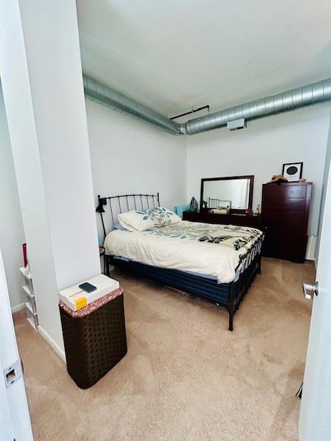 bedroom with light colored carpet