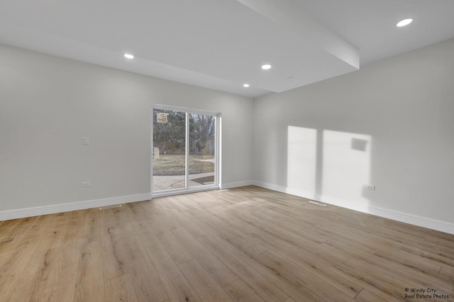 empty room with light hardwood / wood-style flooring