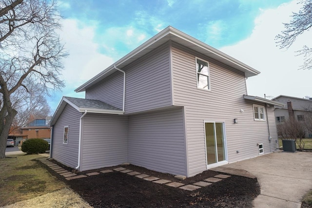 back of house featuring central air condition unit and a patio