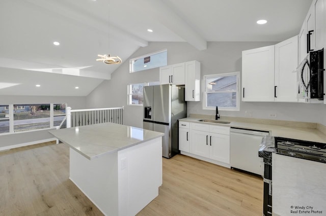 kitchen with stainless steel fridge, white cabinets, sink, decorative light fixtures, and dishwasher