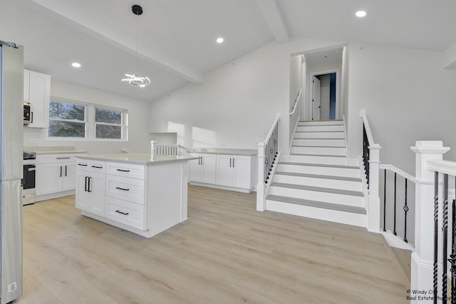 kitchen featuring white cabinets, a kitchen island, pendant lighting, and light wood-type flooring