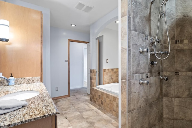 bathroom with vanity and independent shower and bath