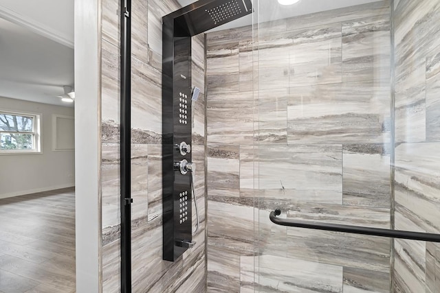 bathroom with ceiling fan, wood-type flooring, and walk in shower