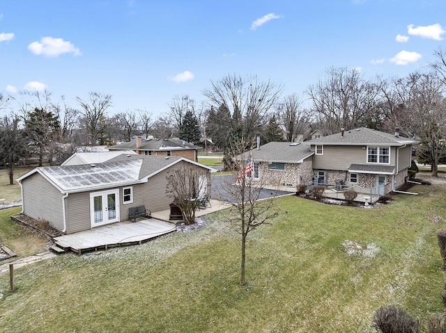 back of house featuring french doors, a yard, and a deck