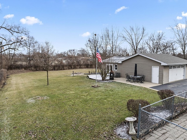 view of yard with a patio and a garage