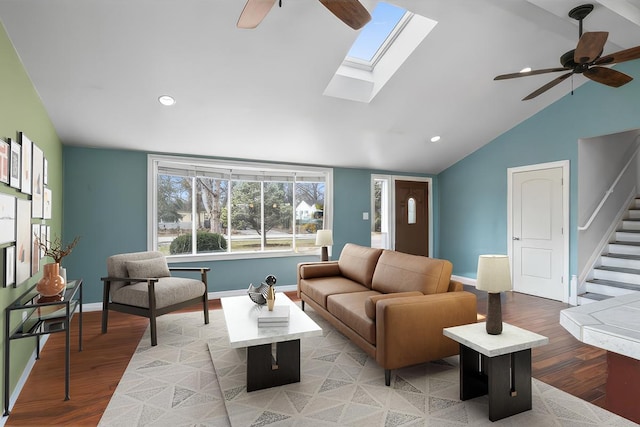 living room featuring hardwood / wood-style floors, ceiling fan, and lofted ceiling