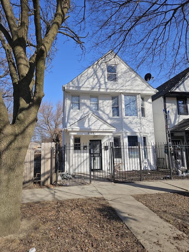 american foursquare style home with a gate and a fenced front yard