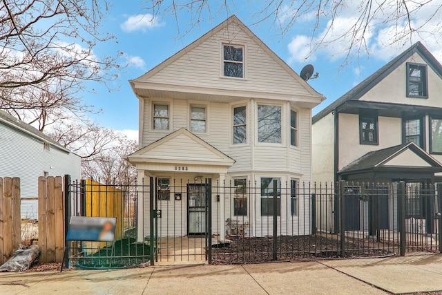 view of front facade featuring a fenced front yard and a gate