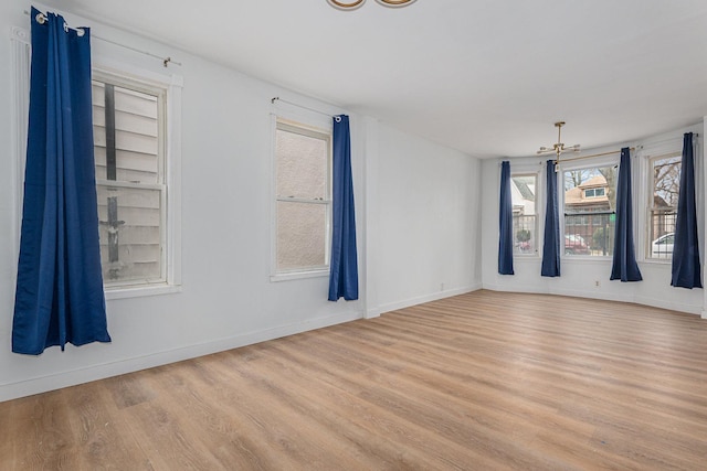 unfurnished room featuring light wood-style flooring and baseboards