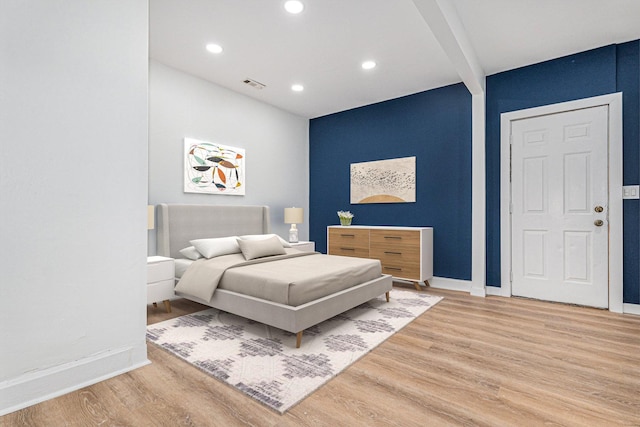 bedroom featuring baseboards, visible vents, beam ceiling, recessed lighting, and light wood-style floors