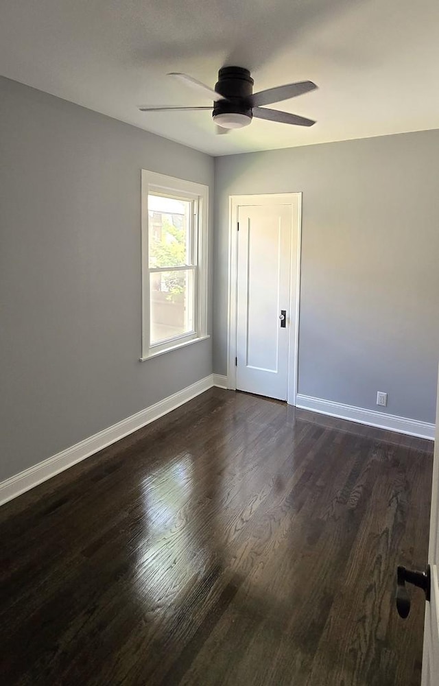 unfurnished room featuring dark hardwood / wood-style floors and ceiling fan