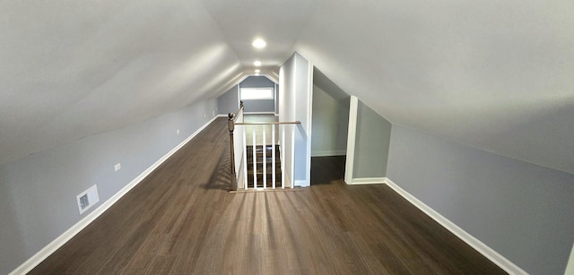 additional living space with dark hardwood / wood-style flooring and vaulted ceiling