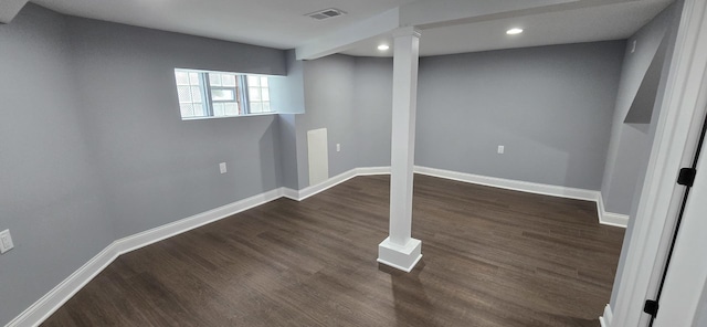 basement with dark hardwood / wood-style flooring