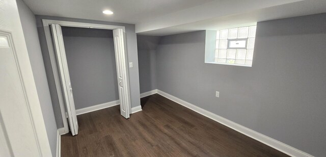 basement featuring dark hardwood / wood-style floors