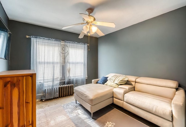 living room with ceiling fan, radiator heating unit, and light carpet