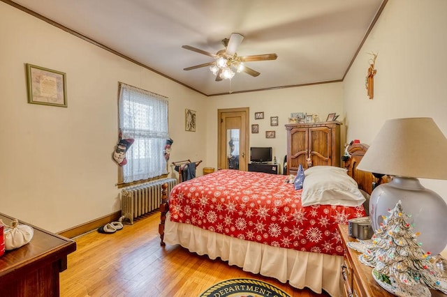 bedroom with ceiling fan, crown molding, radiator, and light hardwood / wood-style flooring