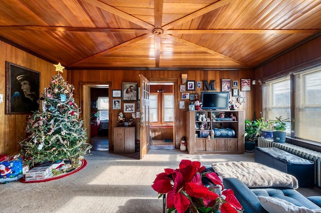 carpeted living room with wooden walls, wooden ceiling, and vaulted ceiling