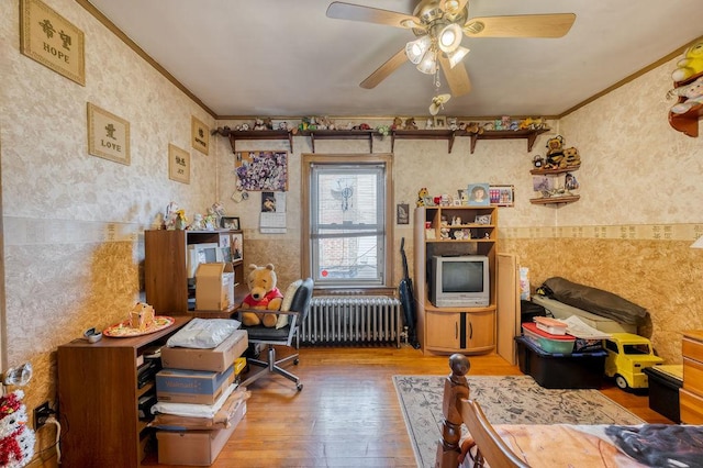 miscellaneous room featuring ceiling fan, radiator heating unit, hardwood / wood-style floors, and ornamental molding